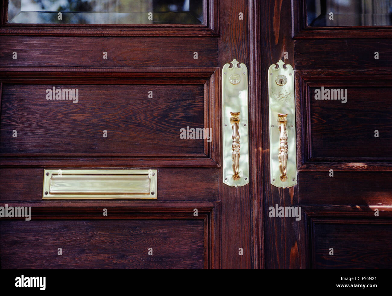 Wooden door & brass hardware of historic old house in downtown Charleston; South Carolina; USA Stock Photo
