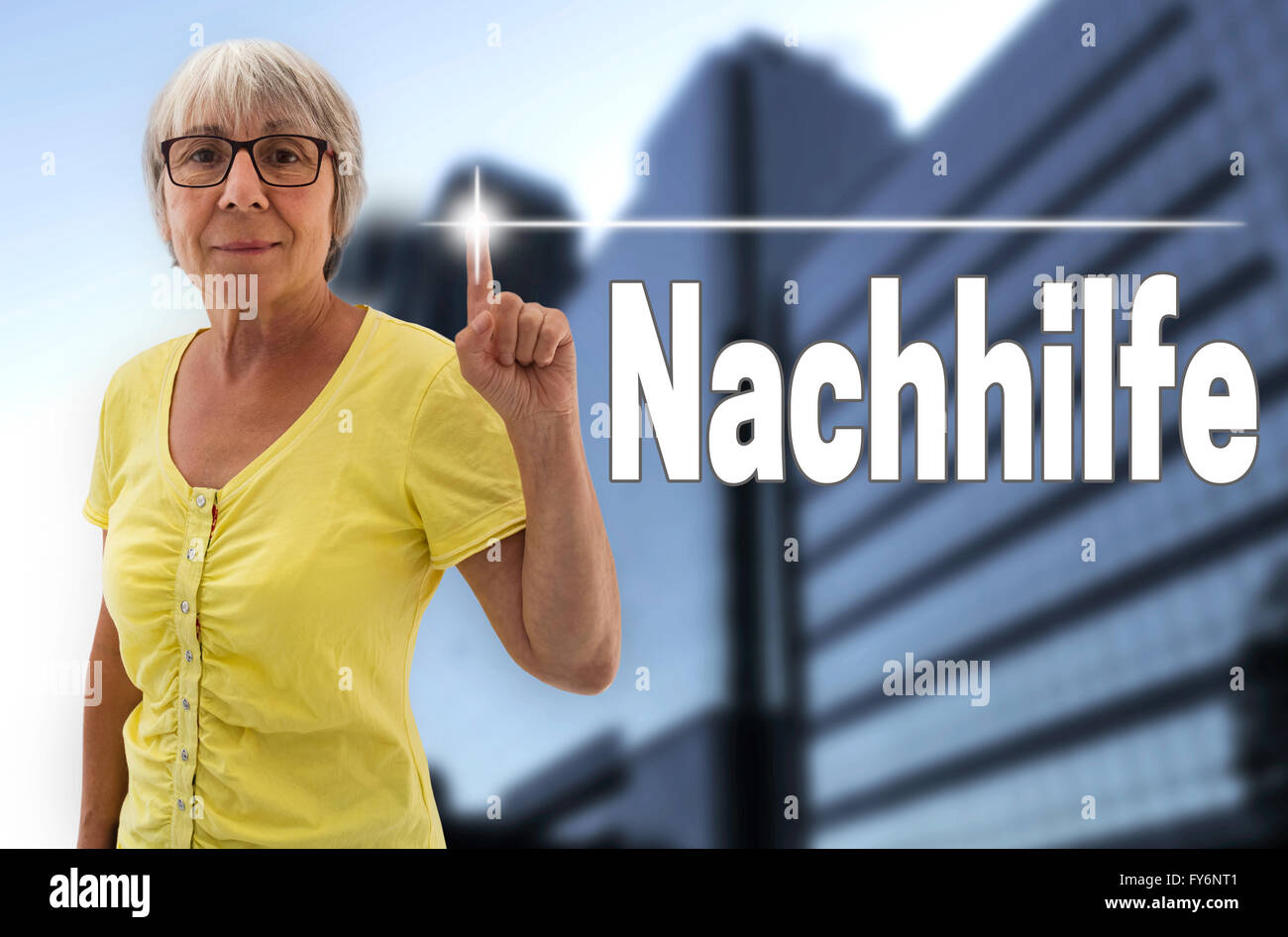 nachhilfe (in german tutoring) touchscreen is shown by senior. Stock Photo