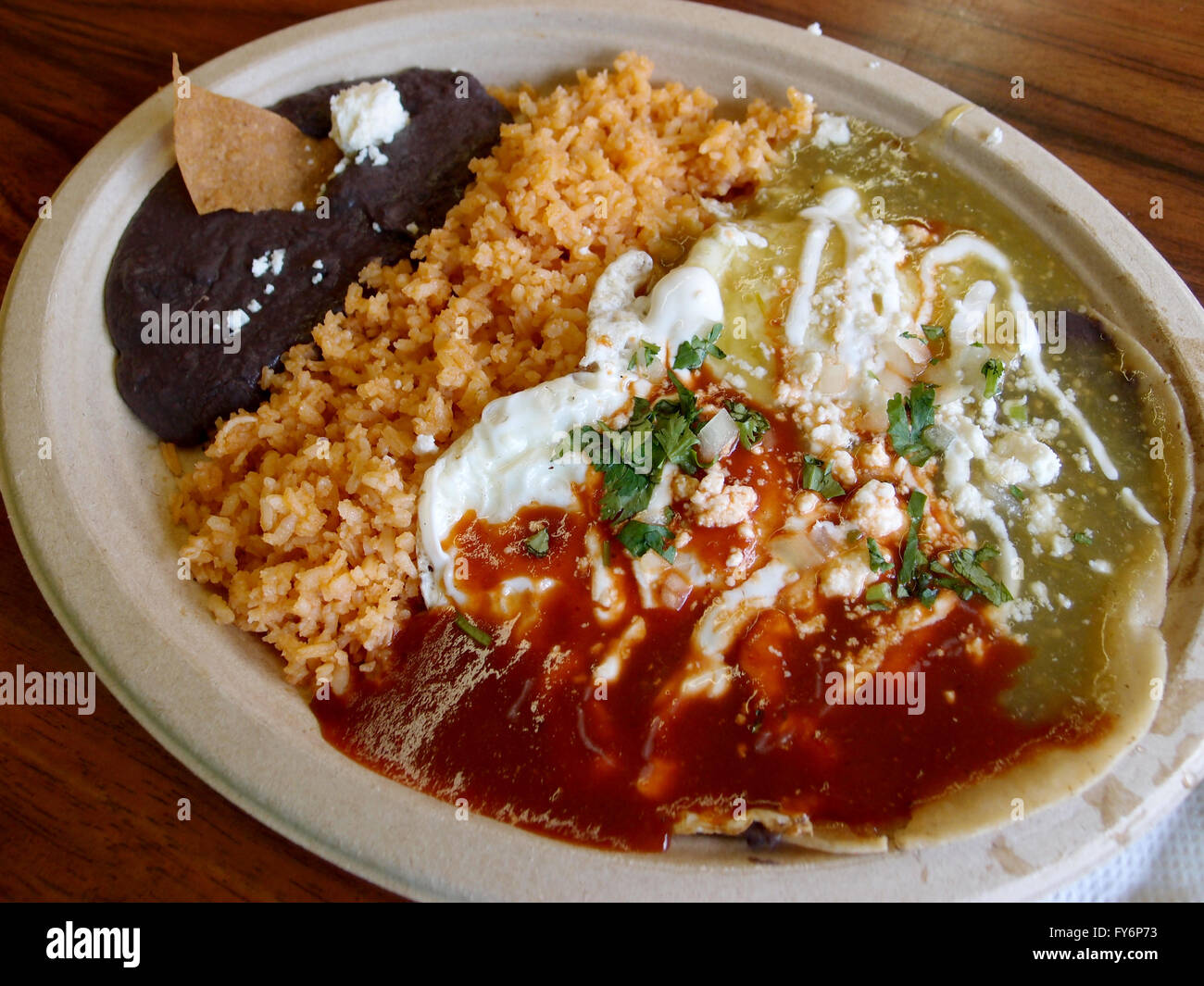 Huevos Divorciados: Divorced Eggs: Two eggs served in the style of Huevos Rancheros but with one egg smotherd in red slasa and t Stock Photo
