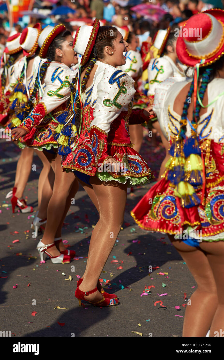 Caporales dance group in ornate red and white costume performing at the annual Carnaval Andino con la Fuerza del Sol in Arica, C Stock Photo
