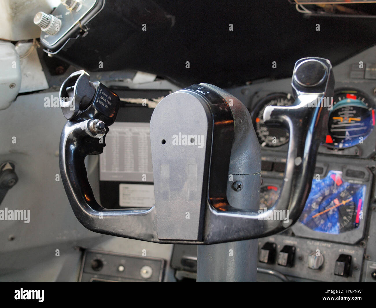 Commercial Airplane Steering Wheel in Cockpit surrounded by dials, and other instruments. Stock Photo