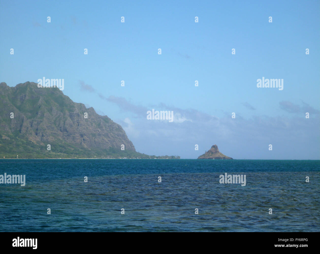 Mokoliʻi or Chinamens Hat a 12.5-acre (5.1 ha), 206-foot-tall (63 m) basalt island 1⁄3 miles (0.54 km) offshore of Kualoa Point, Stock Photo