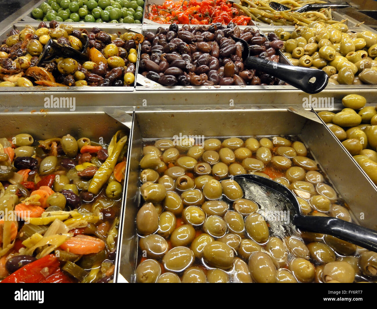 Olive Bar featuring lots of choices and big plastic spoons. Stock Photo