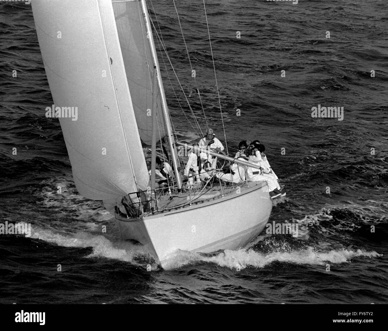 AJAXNETPHOTO. 1979. CHANNEL, ENGLAND. - EDWARD HEATH YACHTING - EDWARD HEATH AT THE WHEEL OF HIS YACHT MORNING CLOUD DURING THE ANNUAL ROUND THE ISLAND RACE.  PHOTO:JONATHAN EASTLAND/AJAX  REF:RIR 2046 Stock Photo