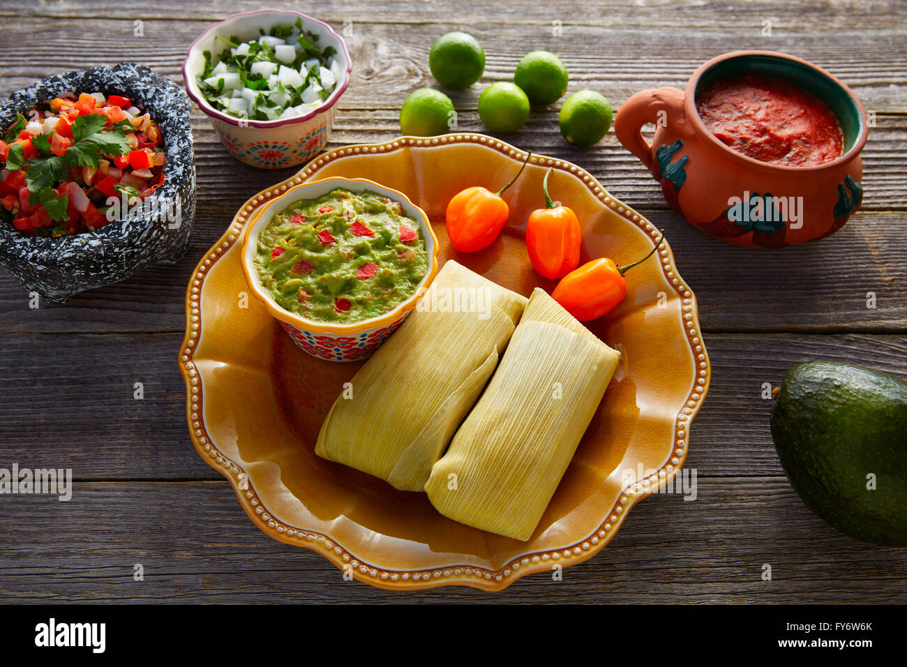 Mexican Tamale tamales of corn leaves with chili and sauces Stock Photo