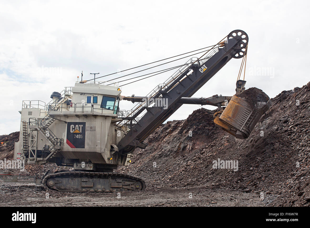 Power shovel is a bucket-equipped machine for digging and loading earth /  fragmented rock onto large mine dump trucks Stock Photo - Alamy