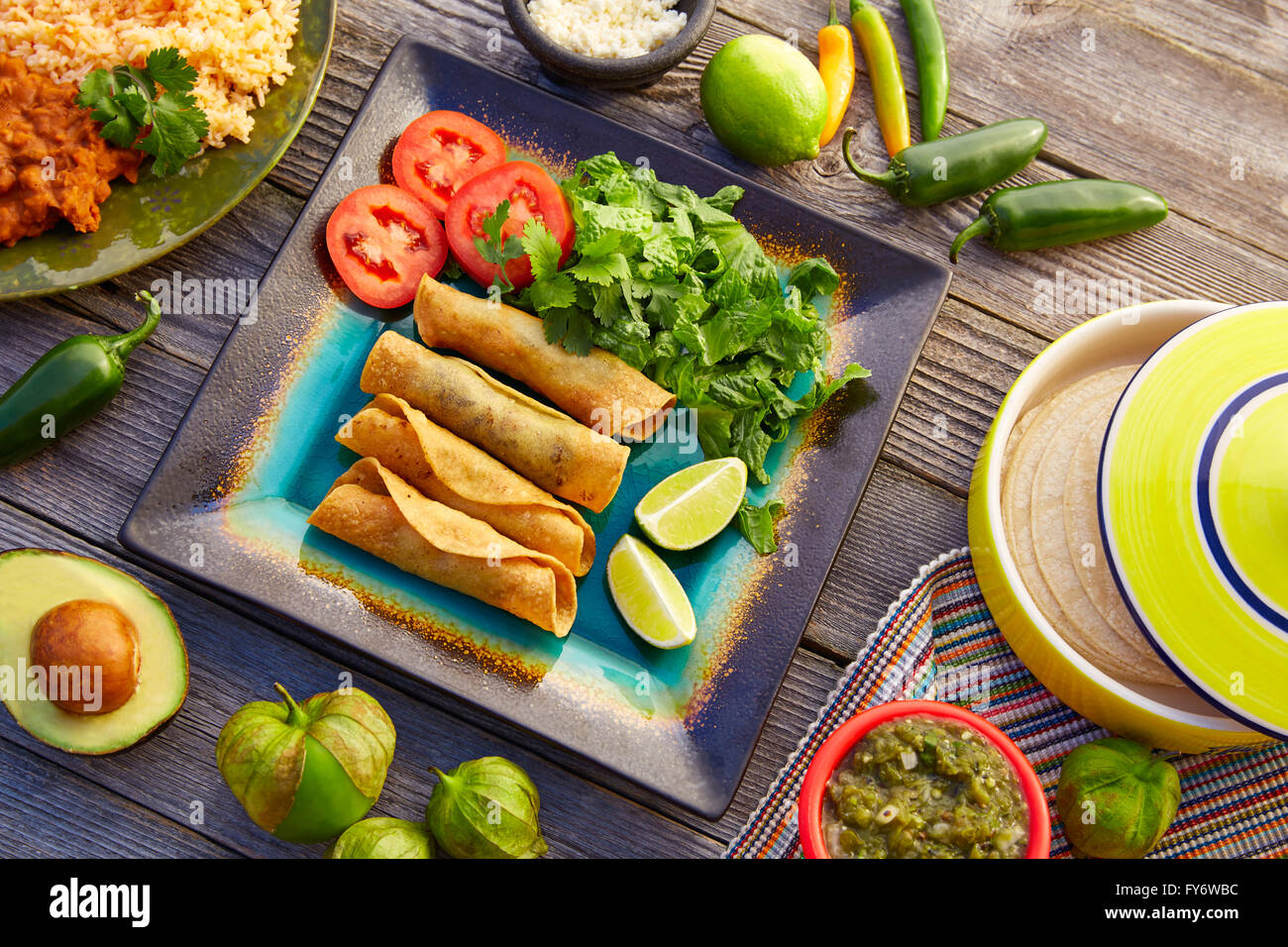 Mexican flautas rolled tacos with salsa and Mexico food ingredients