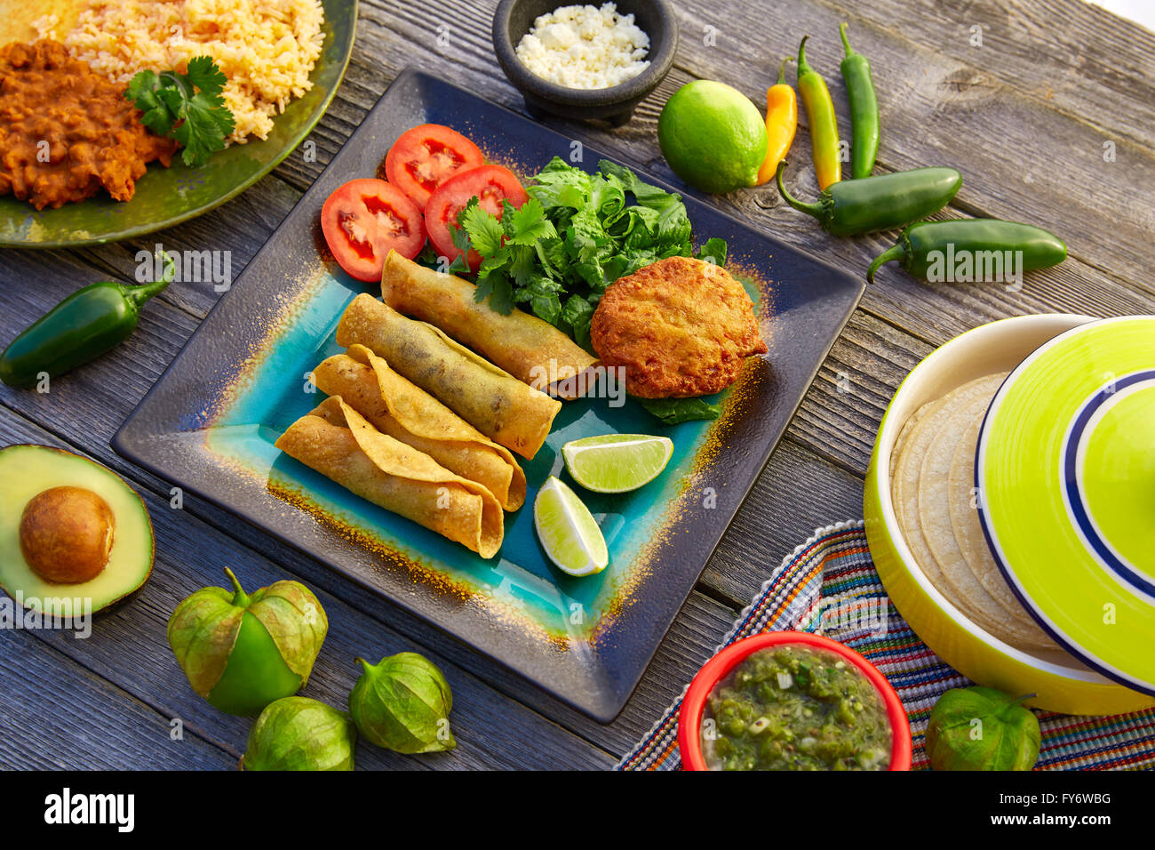 Mexican flautas rolled tacos with salsa and Mexico food ingredients