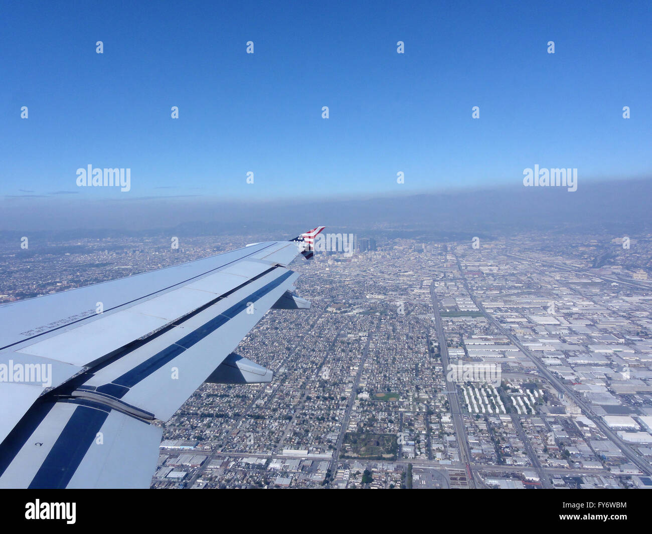 Looking out at a Airplane Wing with View of Downtown LA as plane sets
