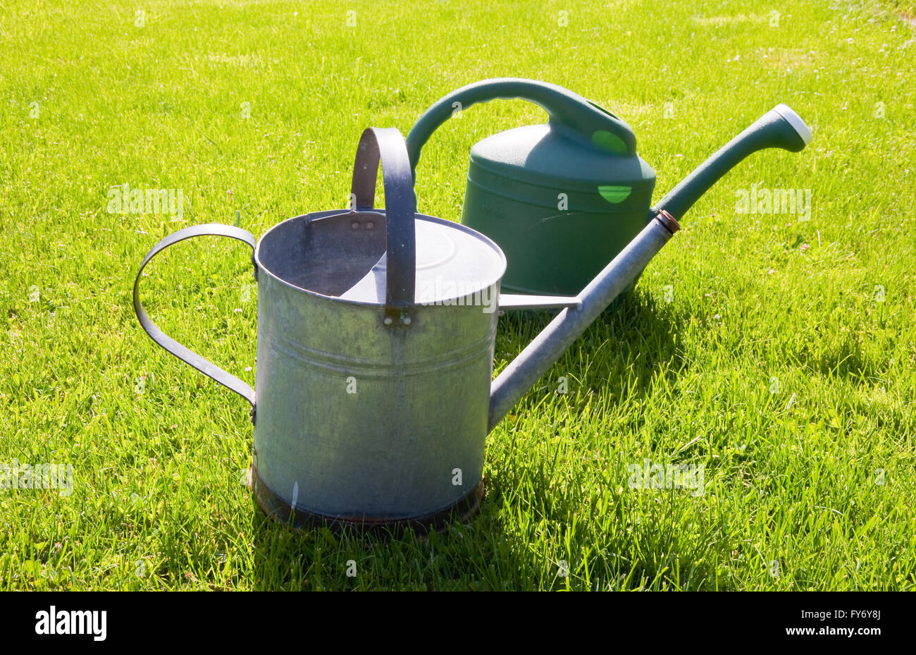 Watering cans in a yard Stock Photo Alamy