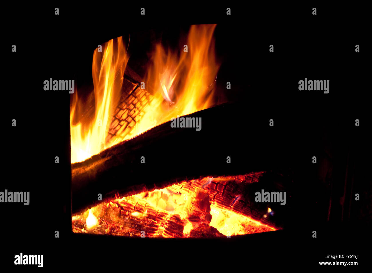 Blazing fire in a wood burning stove Stock Photo Alamy