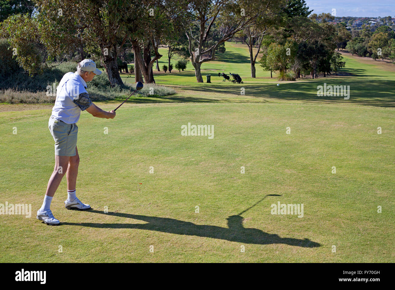A golfer after hitting a tee shot Stock Photo Alamy