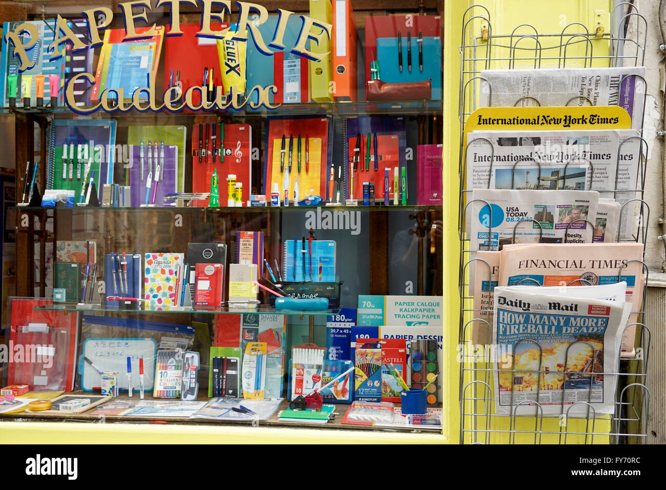 Window of stationery store with newspapers in different languages display beside in Saint-Germain-des-Pres,Paris,France Stock Photo