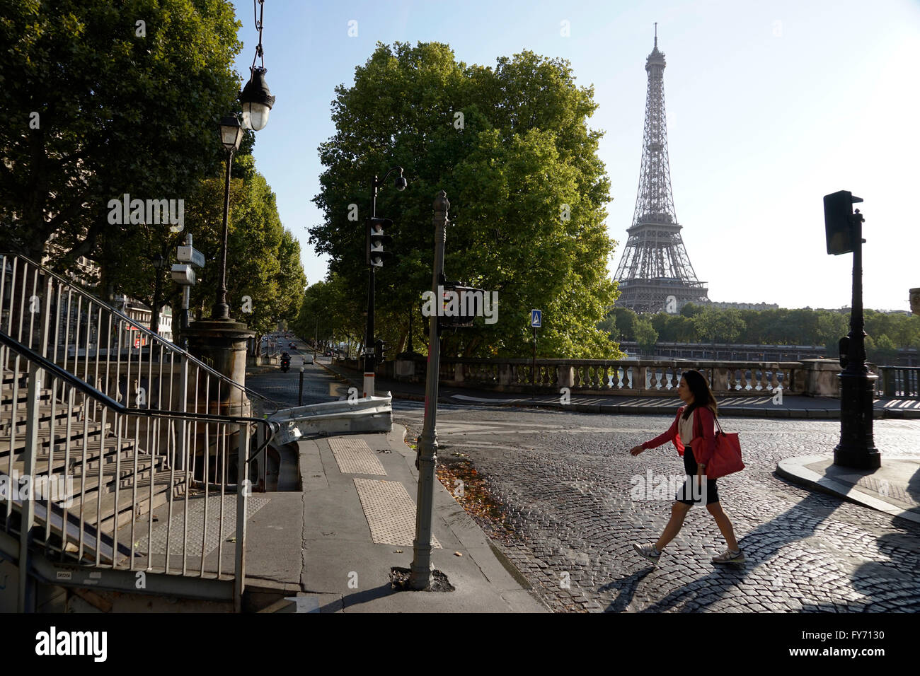 Female pedestrian walking on the end of Pont Bir-Hakeim Bridge with Eiffel Tower in the background, Paris, France Stock Photo