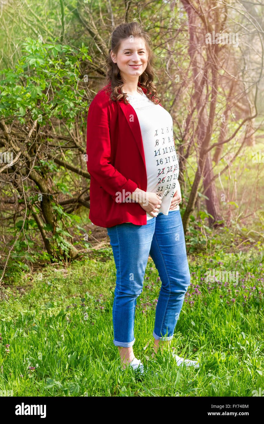 Pregnant woman in red jacket with 