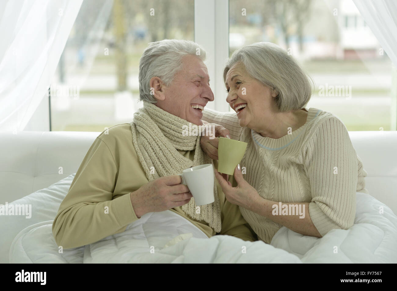 sick  elderly couple in bed Stock Photo