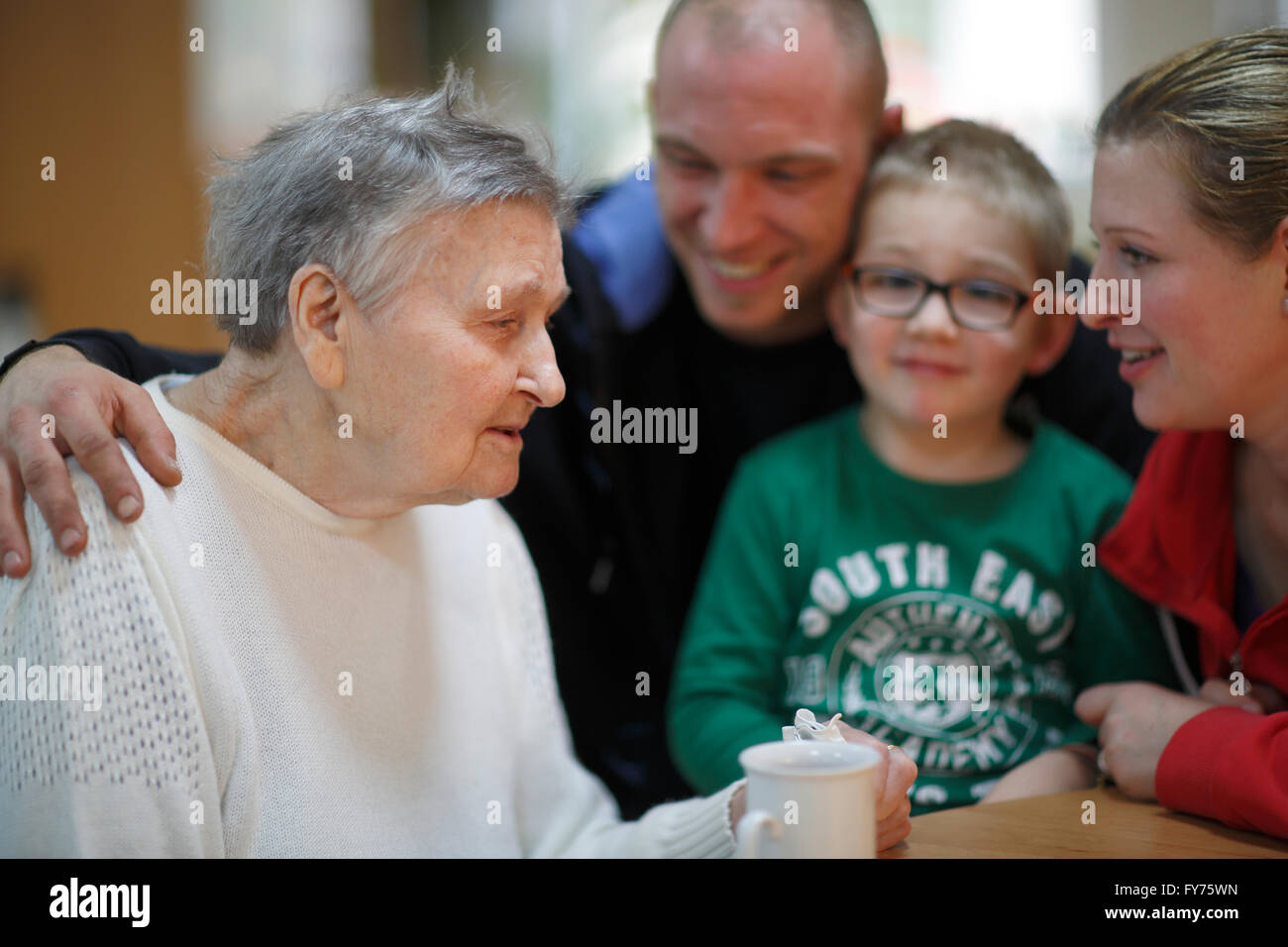 Woman, 83 years, being visited by her family with a great-grandchild, 4 years, nursing home Stock Photo