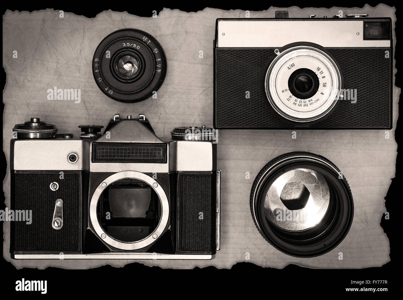 Old manual cameras with lens on wooden desk Stock Photo