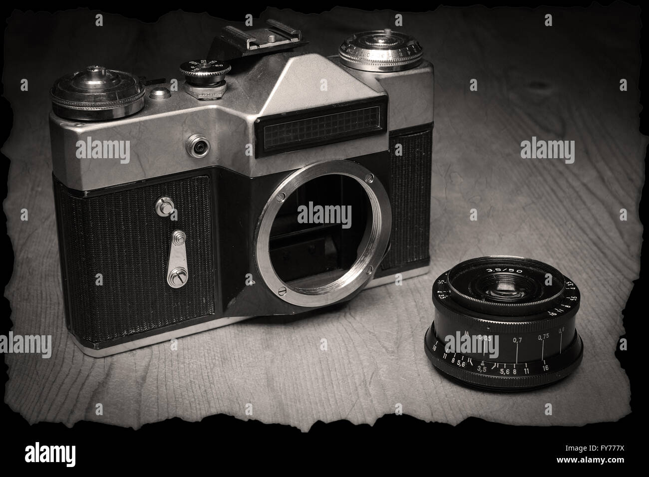 Old manual camera with own lens on wooden desk Stock Photo