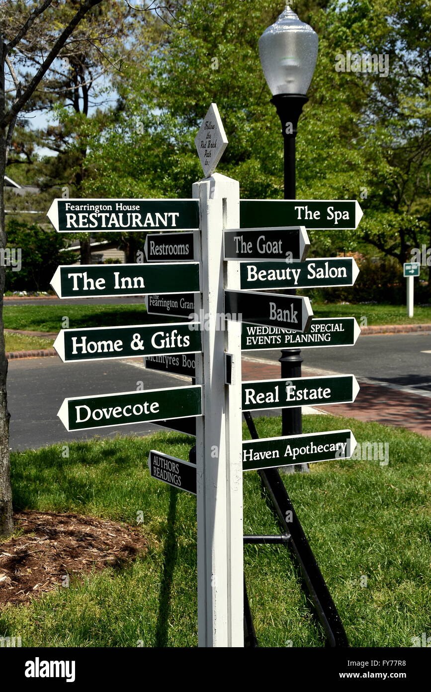 Chapel Hill, North Carolina  Wooden signpost directory points to the shops and restaurants at the Fearington Village Stock Photo