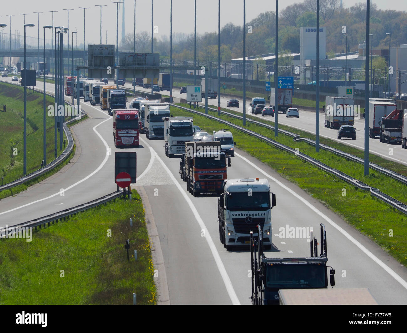 Lots of trucks traffic on the E19 near the Belgian-Dutch border at Hazeldonk (looking towards Belgium) Stock Photo