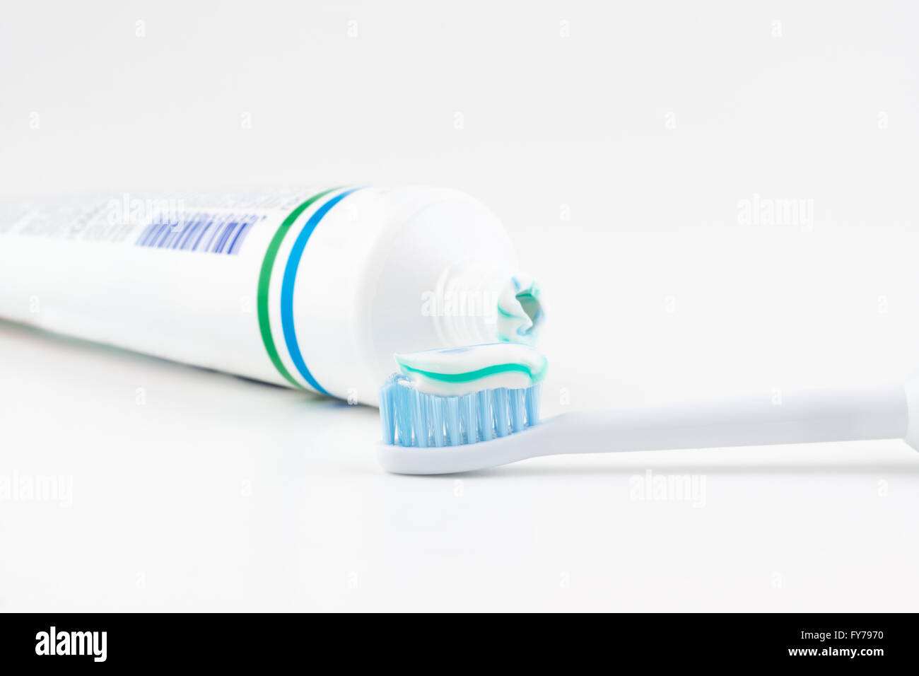 toothpaste tube with a small amount of toothpaste on a toothbrush Stock Photo Alamy