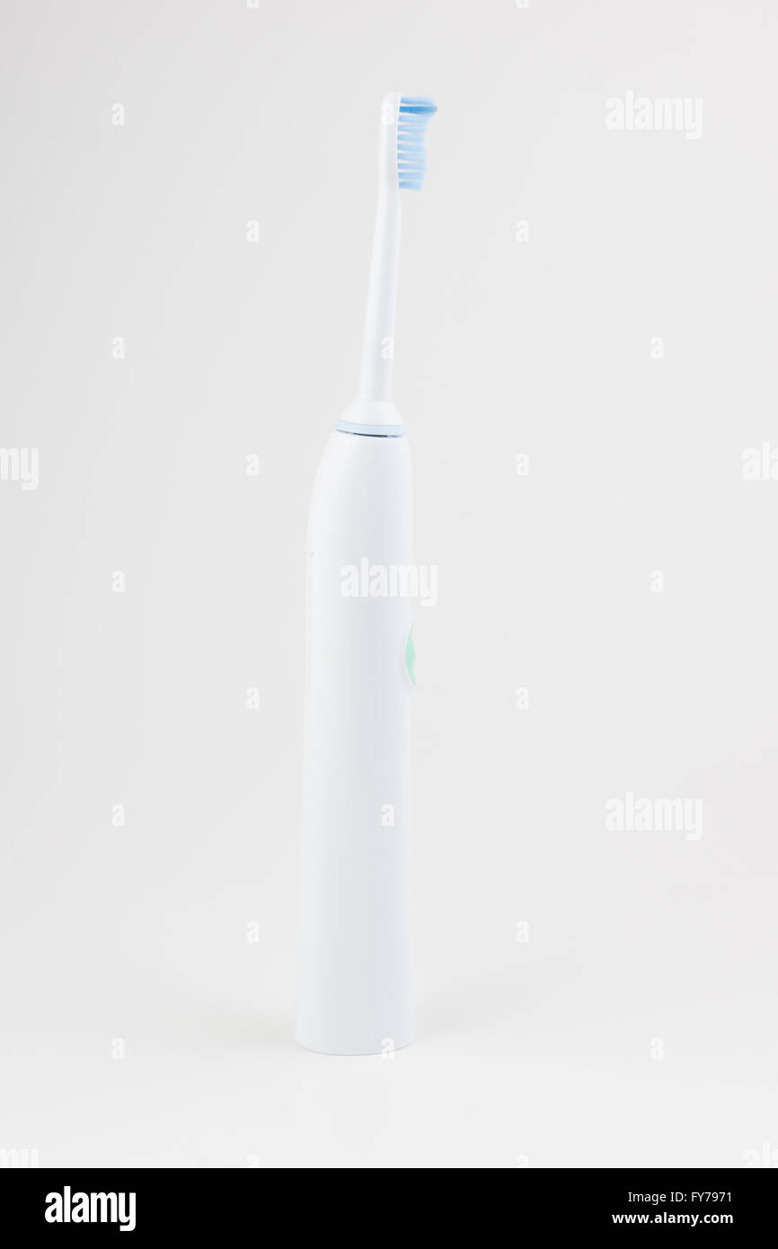 Electric toothbrush standing upright on a white background Stock Photo ...