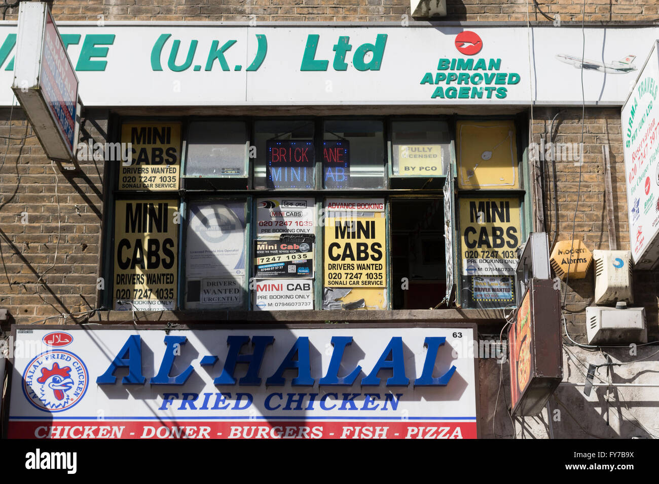 Mini Cabs and Al-Halal Fried Chicken advertising in London's Brick lane Stock Photo