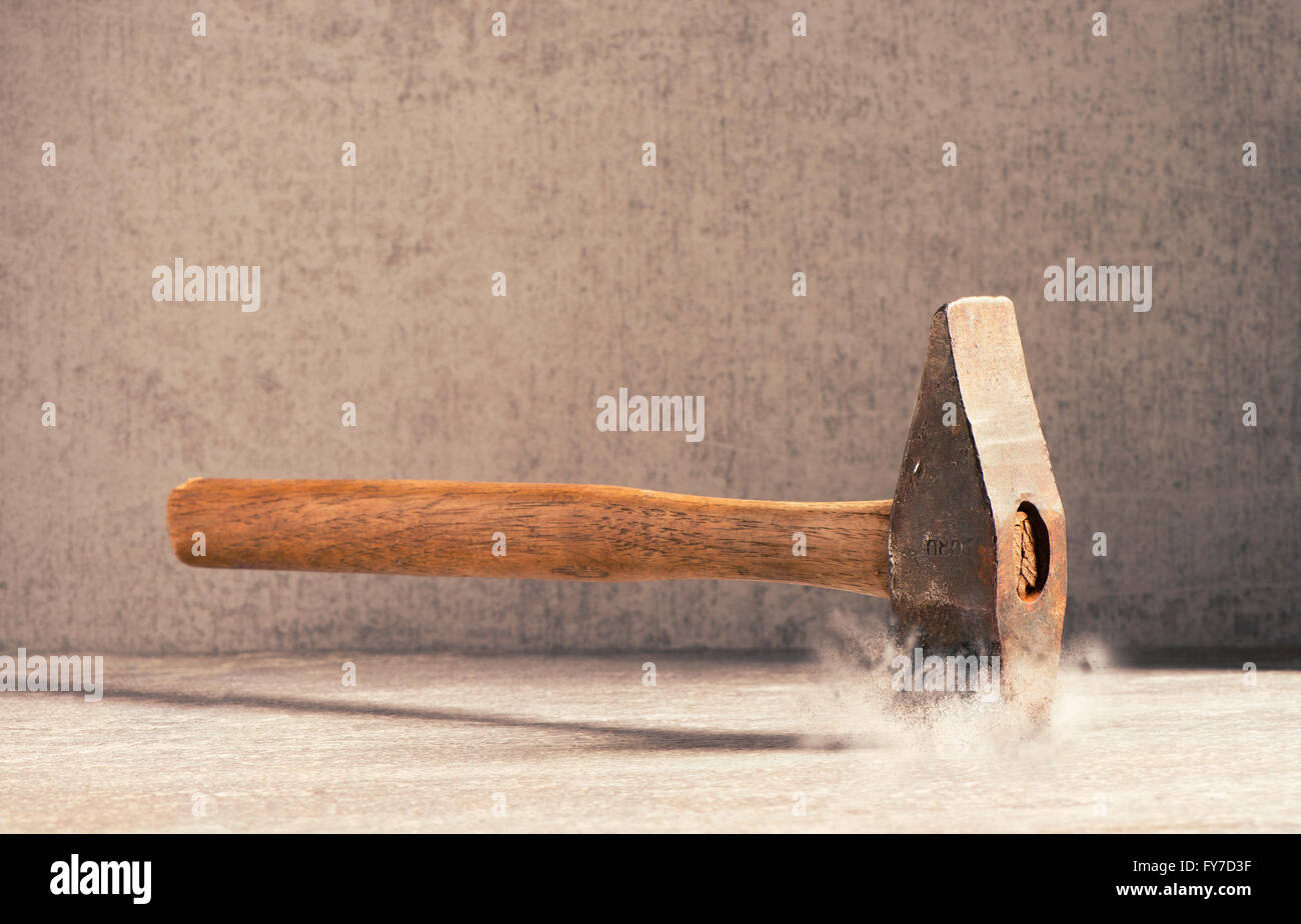 Hammer hitting stone surface. Concept of strenght, impact and force