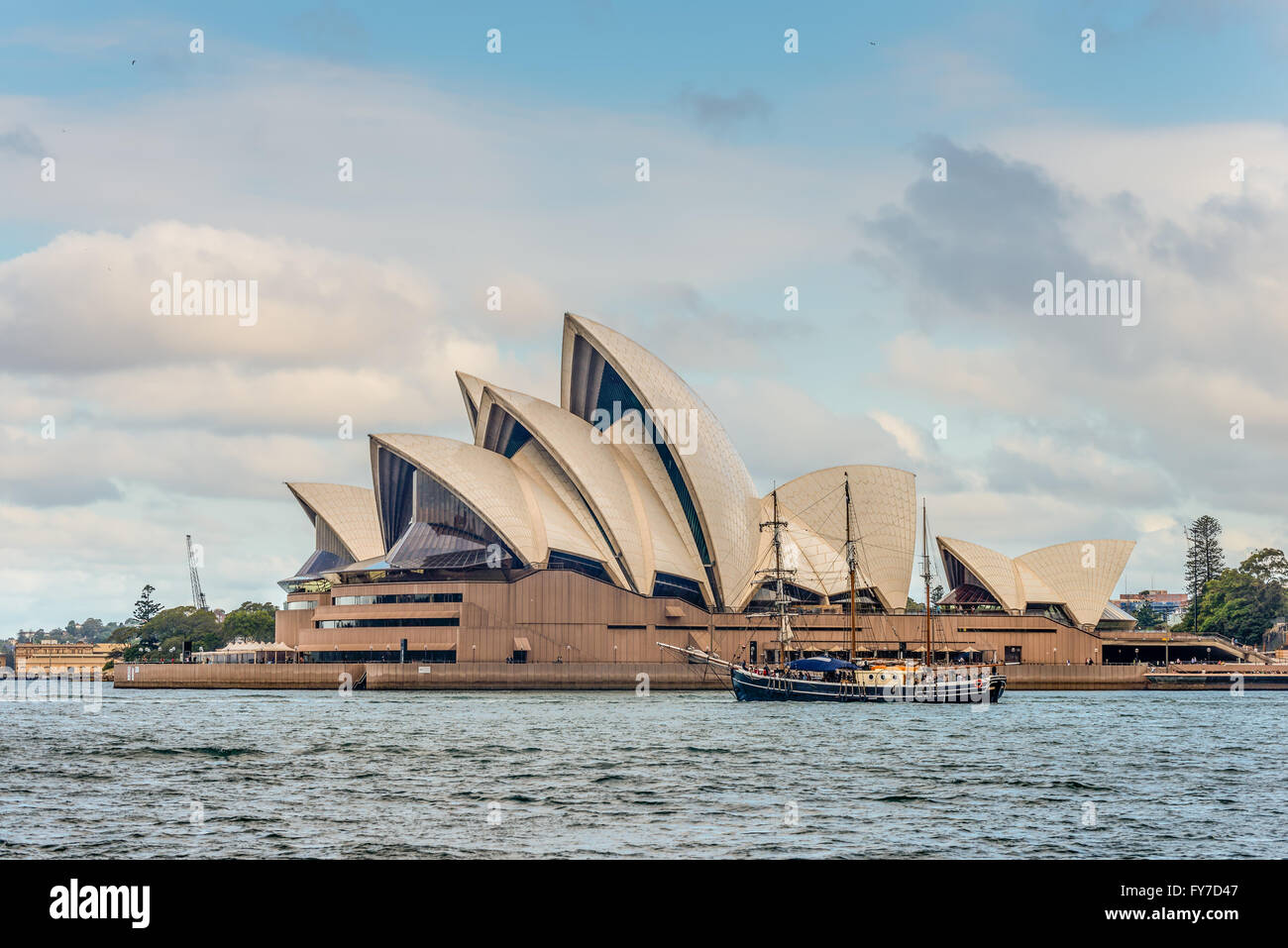 A view of the iconic Sydney Opera House and Tall Ship sailing in the Sydney Harbour, Sydney Stock Photo