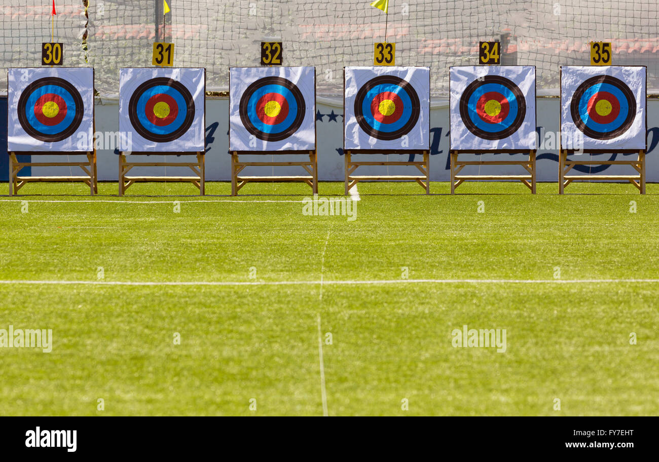 Six archery target rings during an archery competition. Green grass
