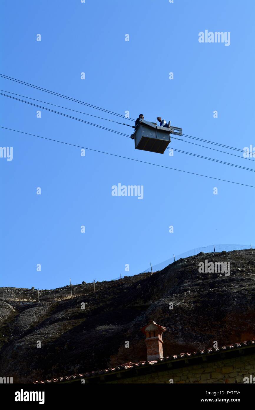 Orthodox priests inside a cable car suspended above Great Meteoron monastery in Greece Stock Photo