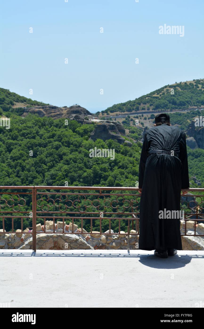 greek orthodox priest looking over a balcony at a monastery in meteora, greece Stock Photo
