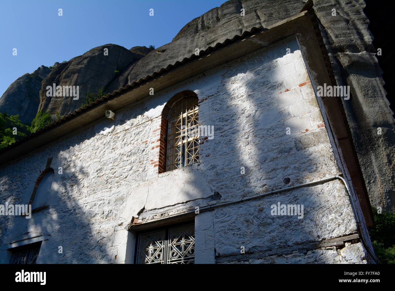 small church at the bottom of a cliff in Meteora, Greece Stock Photo