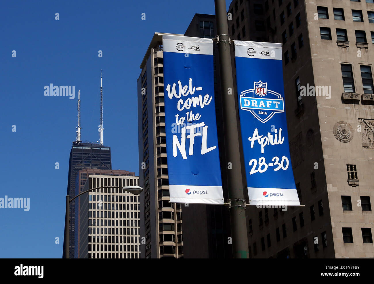 A banner along Michigan Avenue and the John Hancock Center advertises the upcoming 2016 NFL Draft to be held in downtown Chicago Stock Photo