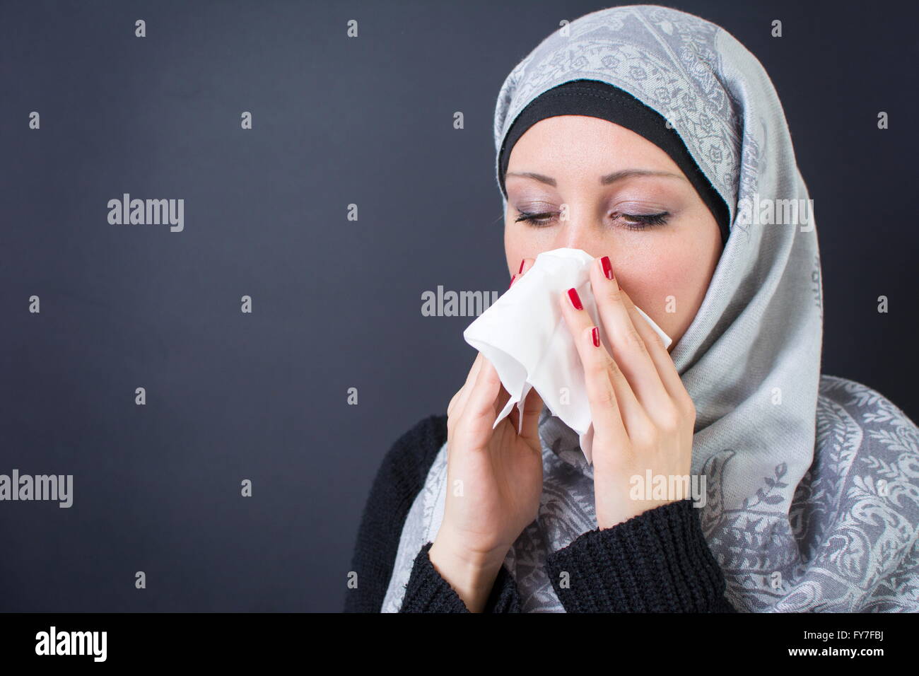 Beautiful muslim woman having a flue Stock Photo