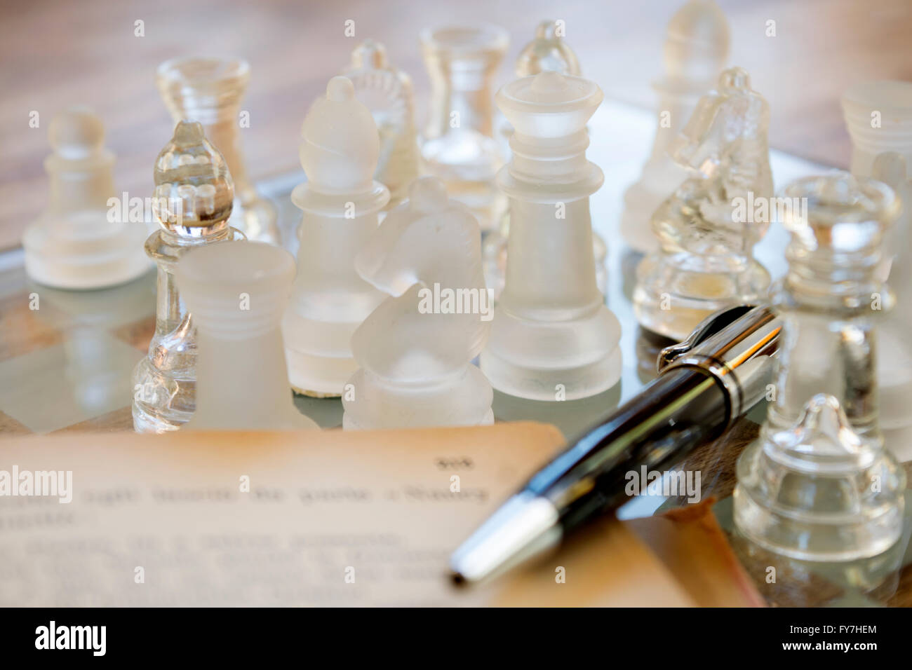 roller pen on a starfish between the chess of a glass chessboard Stock Photo
