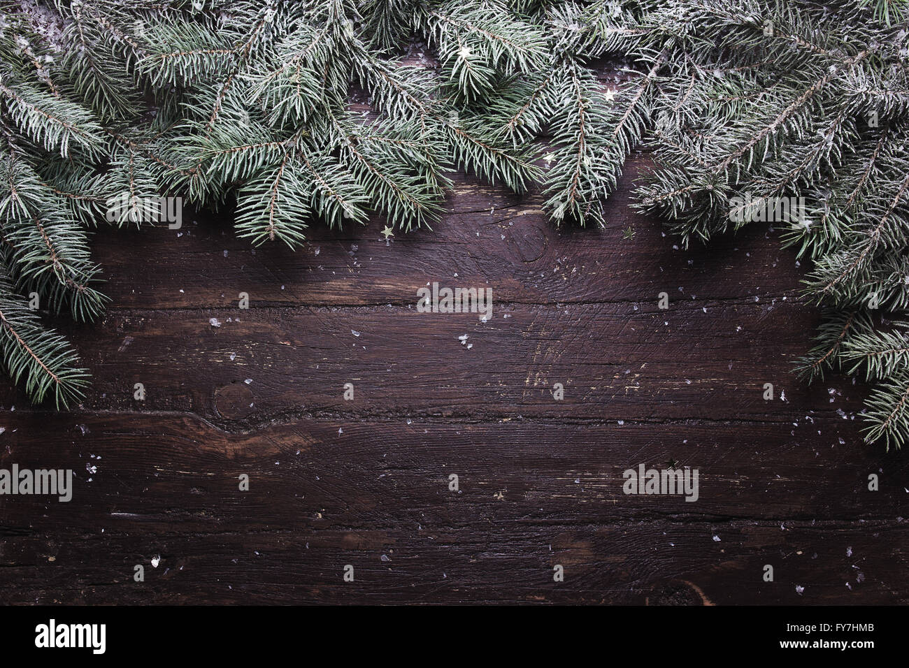 Christmas and New Year decoration composition. Top view of fur-tree branches on wooden background with place for your text Stock Photo