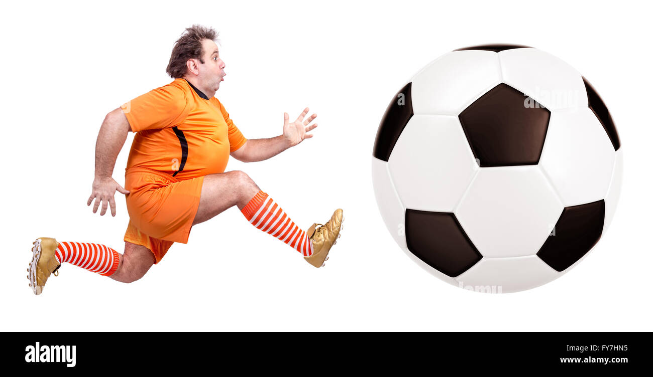 recreational fat football player kicking the ball isolated on a white background Stock Photo