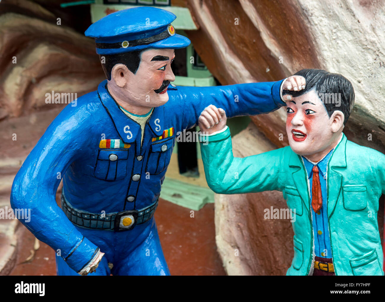 Aggressive policeman attacking a citizen Stock Photo