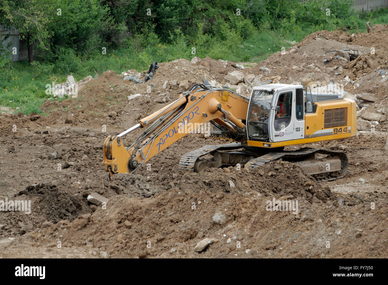 Bucharest, Romania, April 19, 2016: An excavator working removing earth on a construction site. Stock Photo