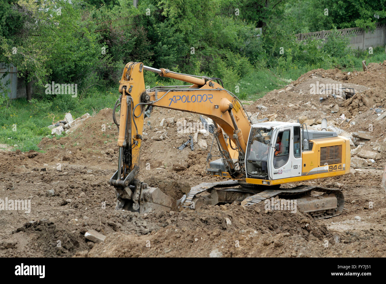 Bucharest, Romania, April 19, 2016: An excavator working removing earth on a construction site. Stock Photo