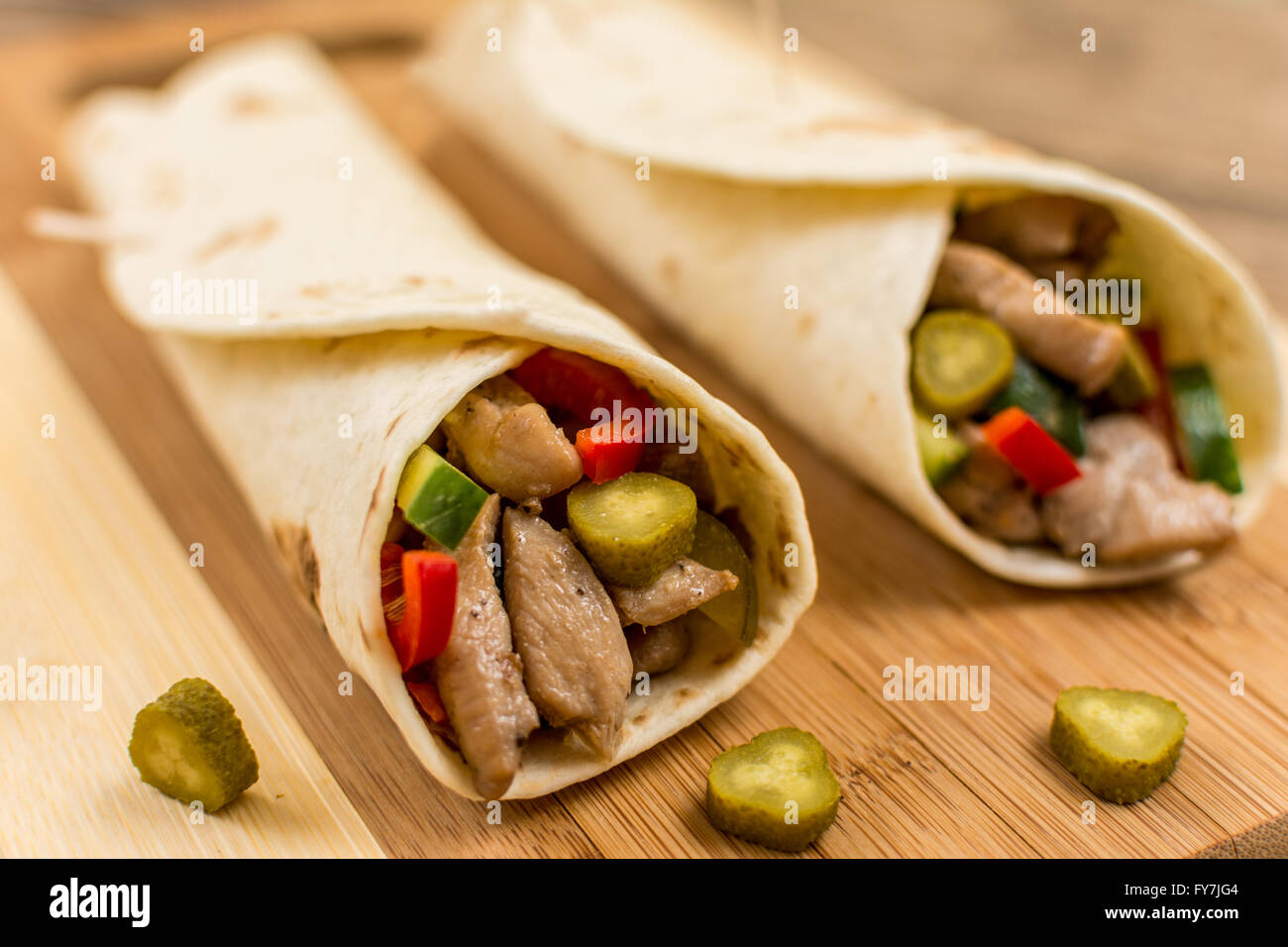 Traditional mexican tortila wrap with meat and vegetables Stock Photo
