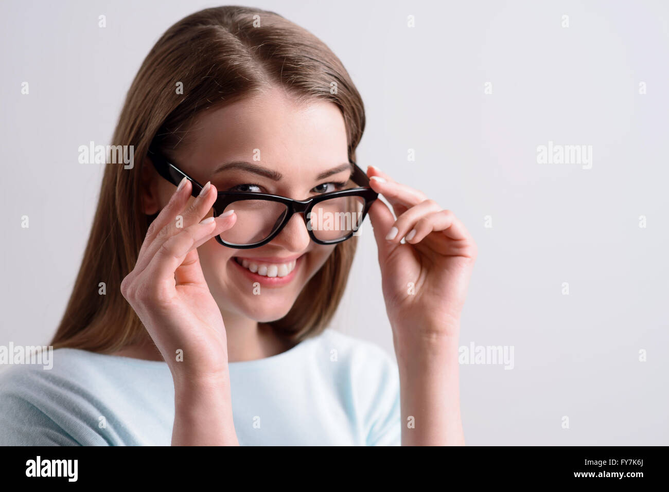 Positive girl holding her glasses Stock Photo