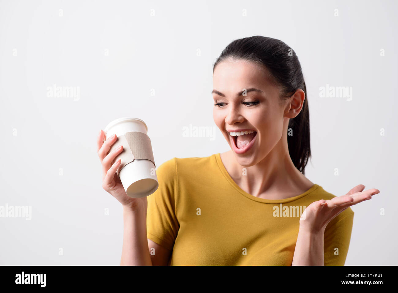 Overjoyed girl drinking coffee Stock Photo
