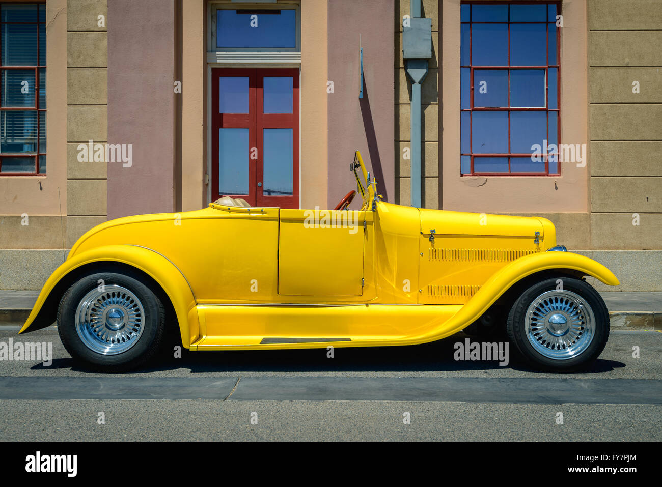 Adelaide, Australia - February 9, 2014: Yellow custom hot rod parked on the street on a bright day Stock Photo