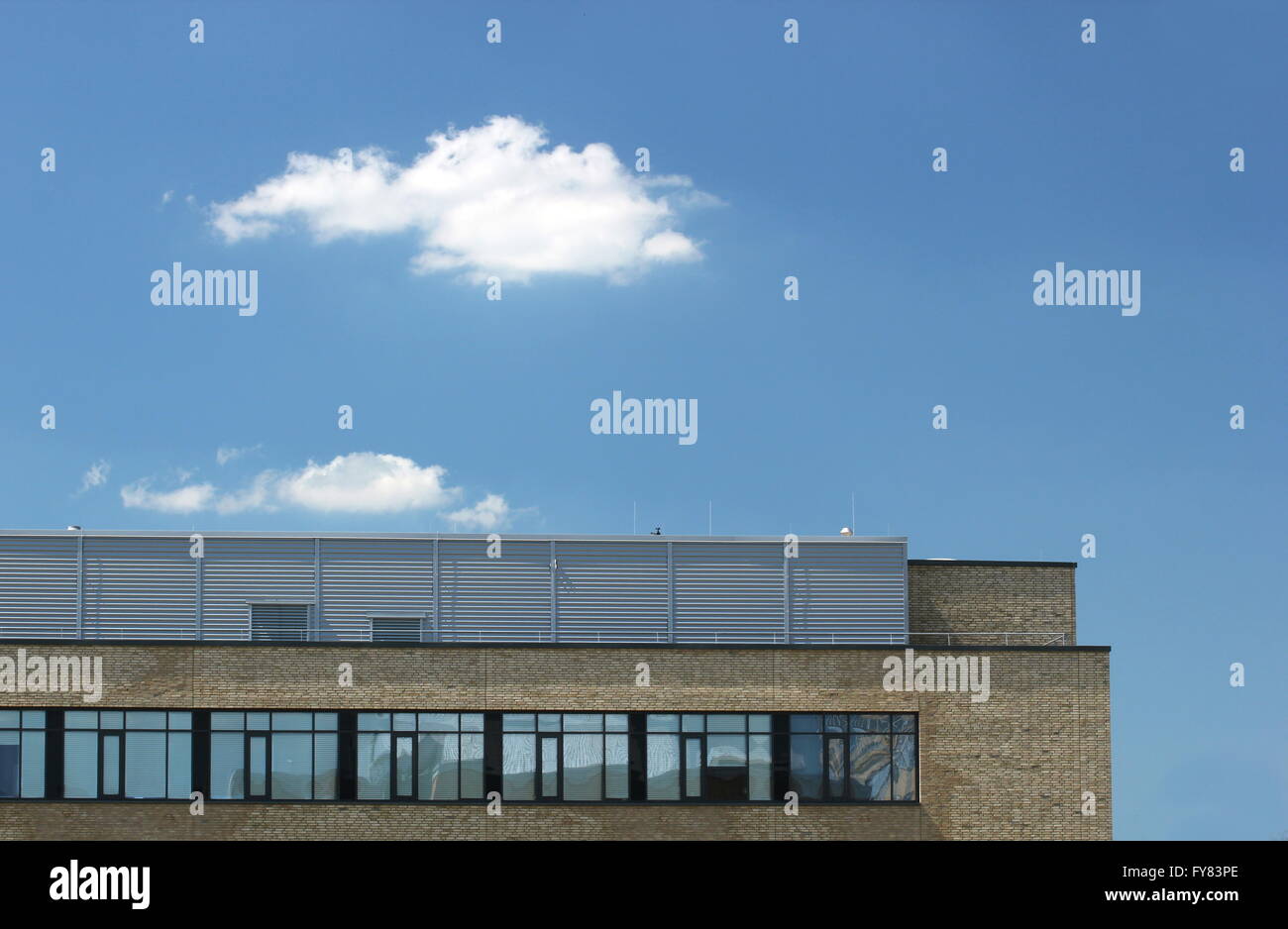 Modern office building with clouds and blue sky Stock Photo - Alamy
