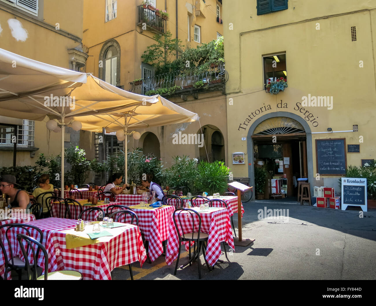 People on outdoor terrace of Trattoria da Sergio restaurant on Piazza Bernardini in Lucca, Tuscany, Italy Stock Photo