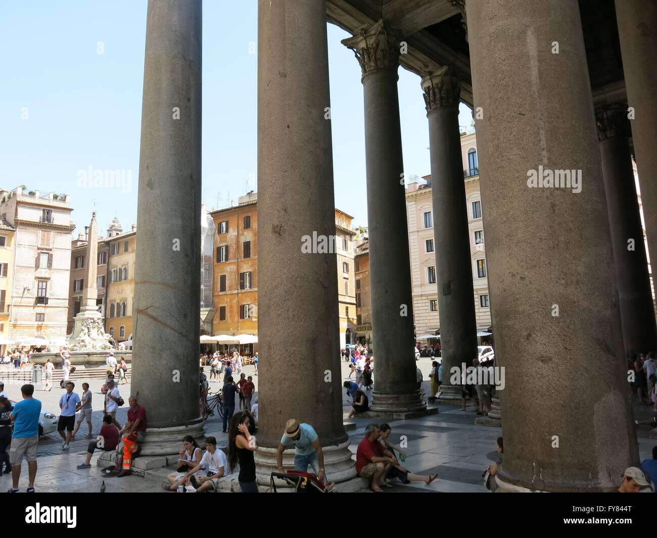 Tourists outside of Pantheon resting in shade of columns on Piazza della Rotonda, Rome, Italy Stock Photo