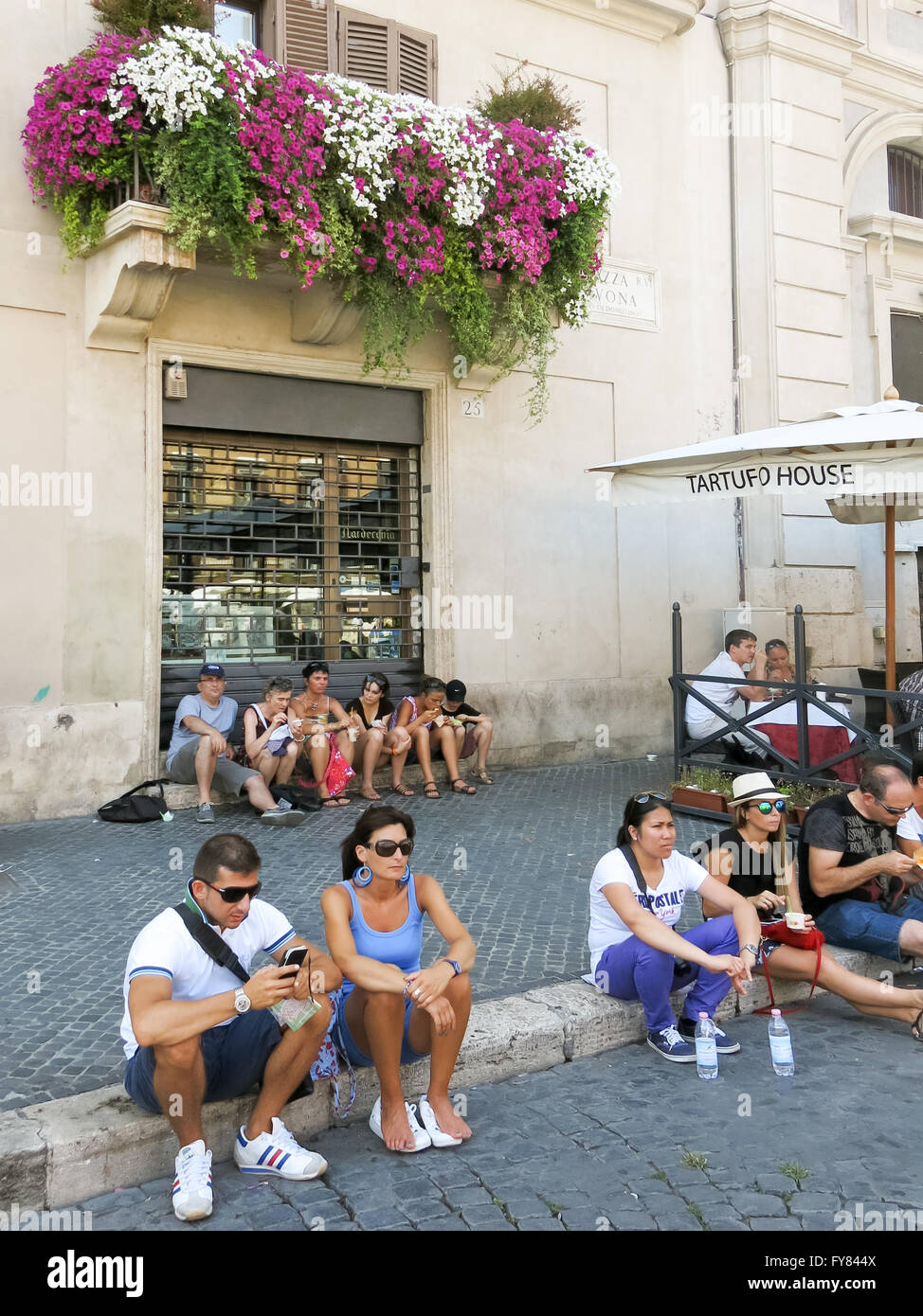 Tourists relaxing on Piazza Navona Square, Rome, Italy on a hot summer day in July Stock Photo